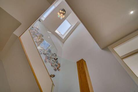 View through hallway up to landing