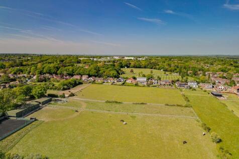 Distant view over paddocks to rear