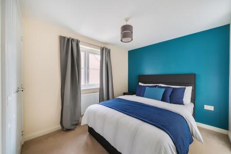 Modern Bedroom with Teal Accent Wall