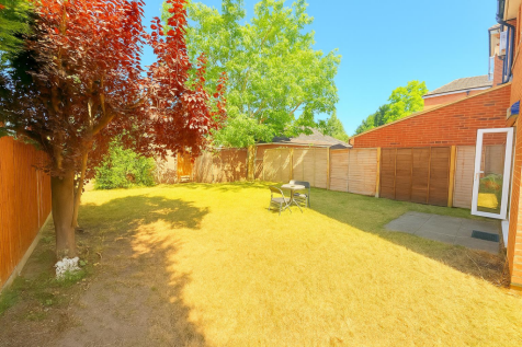 Sunny Garden with Trees and Seating.png