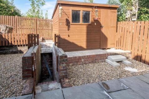 Side of Property and Air Raid Shelter