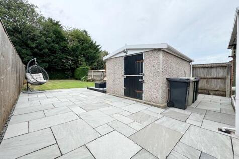Patio area to outbuilding and garden