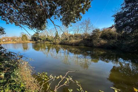 OUTSIDE REAR -COMMUNAL GROUNDS &amp; LAKE