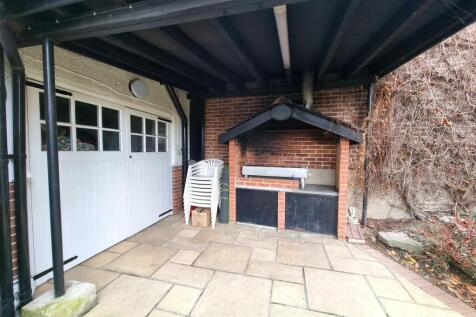 COVERED BBQ AREA &amp; ACCESS TO GARAGE FROM REAR: