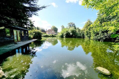 DISTANT VIEW OF THE PROPERTY FROM THE POND AREA: