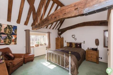 Master bedroom with vaulted beamed ceiling