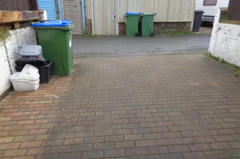 Parking space via access road to rear