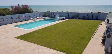 Balcony view of garden,pool, jacuzzi, beach and se