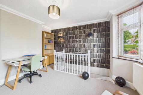 Versatile office space and stairs leading to Basement Living Space