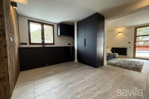 A modern, minimalist interior features light gray 