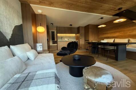 A cozy, modern living room with wooden accents fea