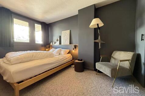 Modern bedroom with a minimalist design, featuring