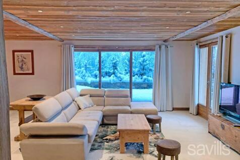 Cozy living room with a sectional sofa, wooden cei