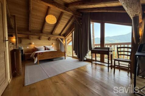 This picture shows a cozy wooden bedroom with a sl