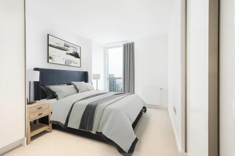Experience tranquility in this elegantly designed bedroom with breathtaking city views.