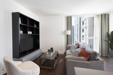 Experience urban elegance in this contemporary living room with ample natural light.