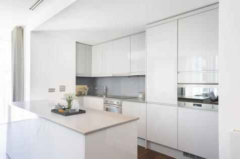 Experience culinary bliss in this open, modern kitchen with elegant finishes.