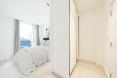 Experience tranquility in this modern bedroom with stunning city vistas.