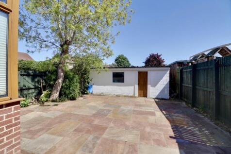 Rear garden with garage beyond