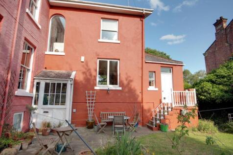 Part of the back garden and the rear of the apartm