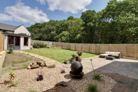 Rear garden fringed by woodland