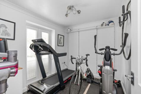 Gym with doors to the back garden