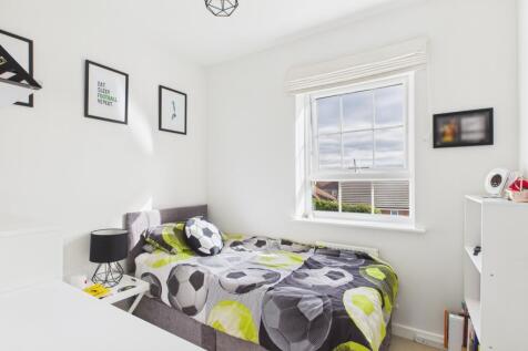 Built in wardrobes and a big window in this single