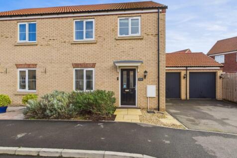 A single garage and driveway with parking in front