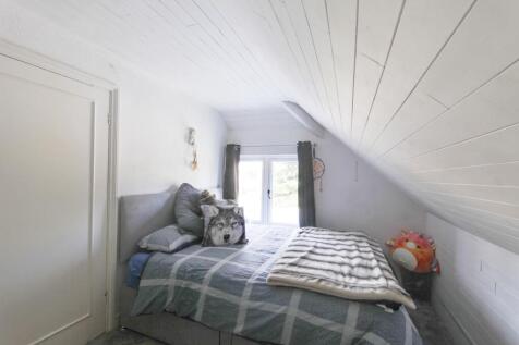 Bedroom 5 with fitted storage wall
