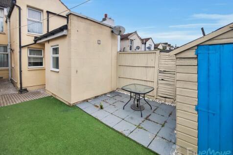 Rear Garden with a patch of green grass - seating 
