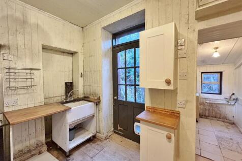 Kitchen showing utility area.