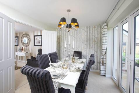 The adjoining dining area features double doors to the garden
