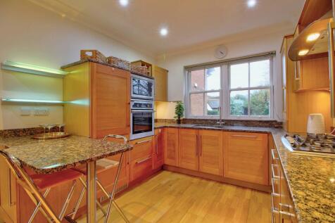Granite breakfast bar &amp; backlit display shelves