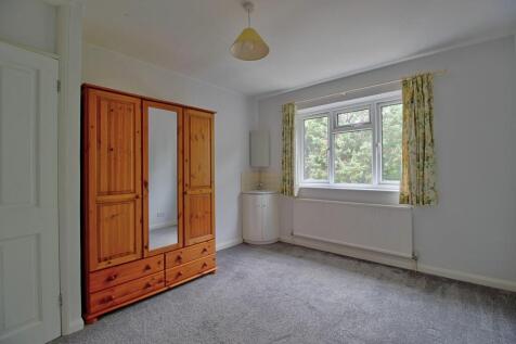 Bedroom Two with wash basin and garden views