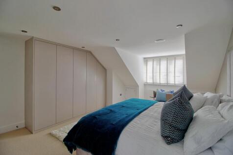 Master Bedroom with bespoke wardrobes &amp; eaves cupb