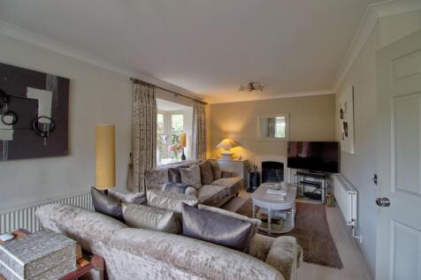Living room has two large bay windows