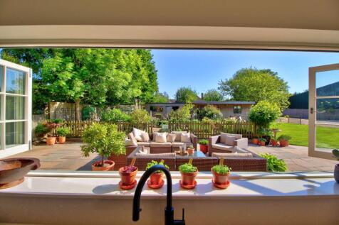 Bifold windows overlooking sunny kitchen garden