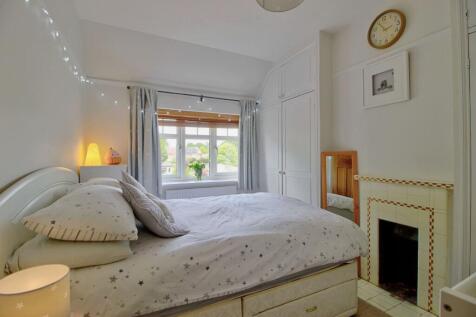 Bedroom Two with storage and feature fireplace