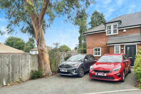 Outside View Of The Property With Driveway Parking