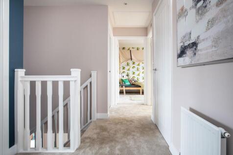 The central staircase leads to the bedrooms and bathrooms