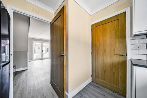 Kitchen with doors to living room and entrance hal