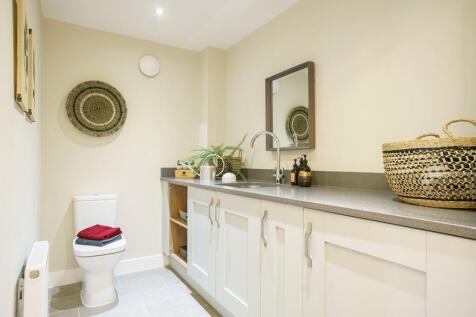 Large cloakroom with shelving and room for the washing machine