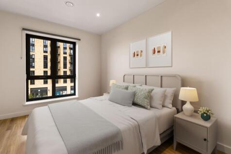 Experience tranquility in this beautifully designed bedroom featuring stylish decor and ample natural light.