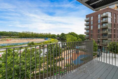 Enjoy a tranquil escape with this stunning balcony view of nature and urban charm.