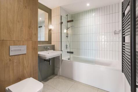 Experience luxury in this beautifully designed modern bathroom, combining wood and tile for a stunning aesthetic.