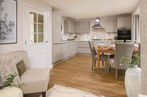Open-plan kitchen with integrated appliances, dining area &amp; family room with French doors leading on
