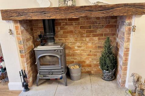 LOG BURNER IN STONE FIREPLACE.jpg