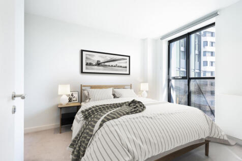Experience urban tranquility in this stylish bedroom, featuring natural light and sleek design.