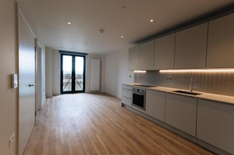Experience modern elegance with this open-plan kitchen and living area, designed for comfort and style.