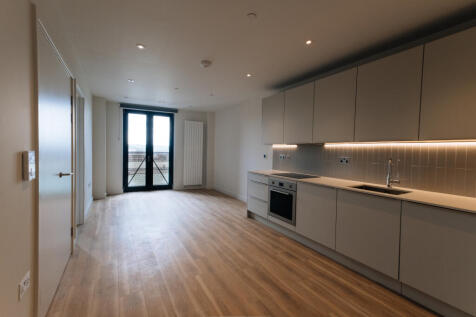 Experience modern elegance with this open-plan kitchen and living area, designed for comfort and style.